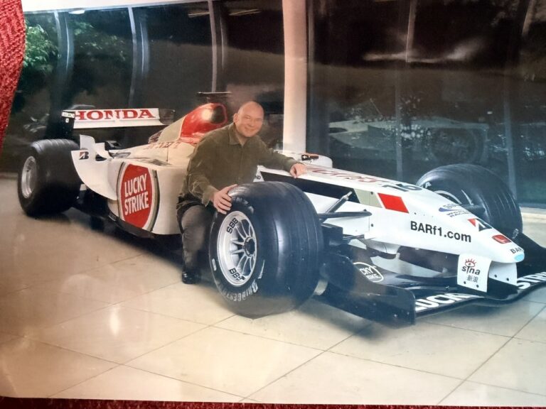 Mark Hendy with a BAR Honda Formula 1 car at the Brackley factory, mid-2000s.